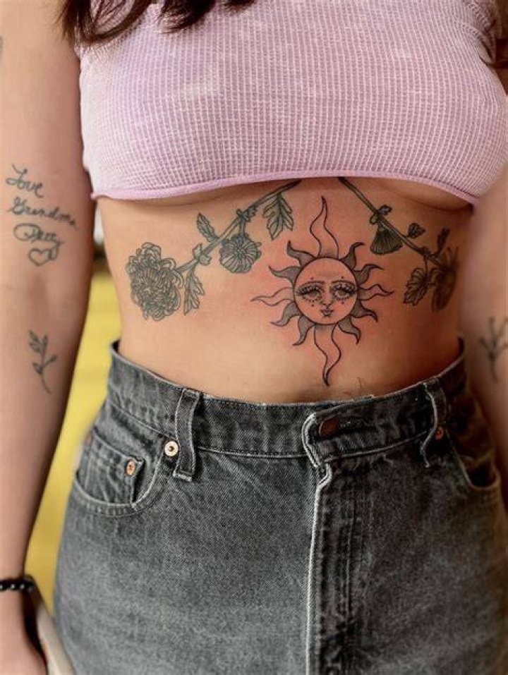 stomach tattoo sun funky face floral chrysanthemum Side Stomach Tattoos
